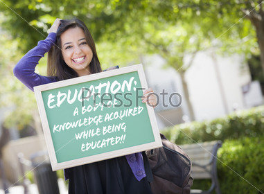 Excited Mixed Race Female Student Holding Chalkboard With Success and the Definition Written on it.