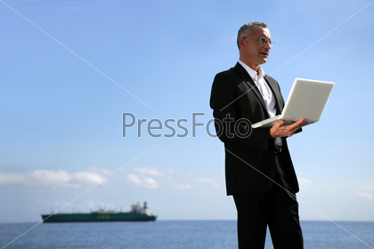 Man in suit with a laptop computer