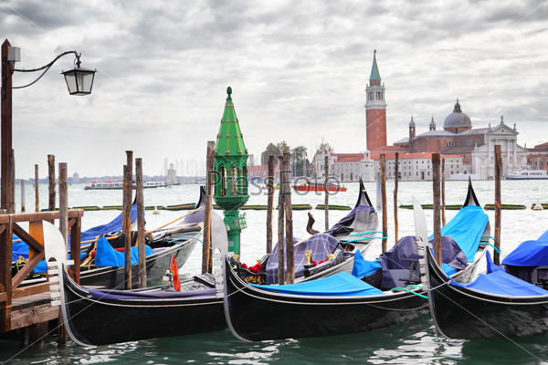 Gondolas near Saint Mark square and San Giorgio di Maggiore church in the background - Venice, Italy