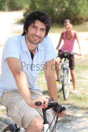 Couple riding bikes in the countryside