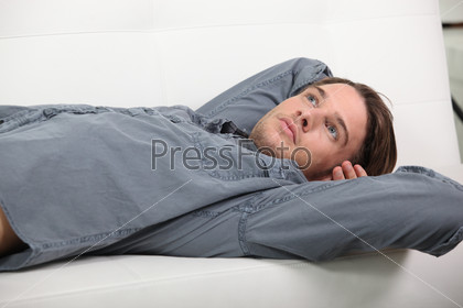 Man lying on the sofa, stock photo