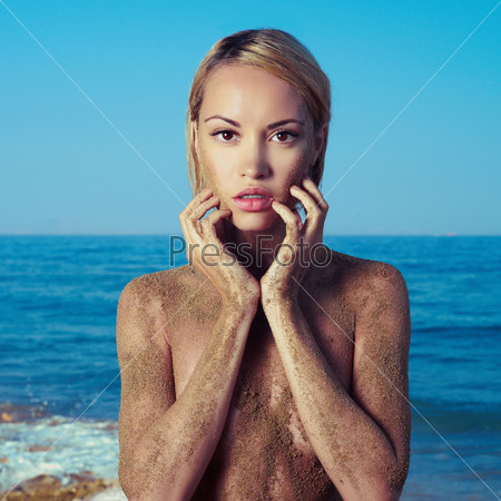 Nude blonde at the sea