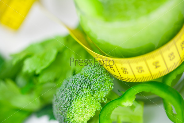 measuring tape,broccoli,pepper,celery and glass with celery juice