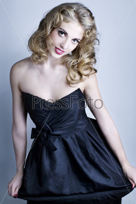 Young blonde lady in black dress