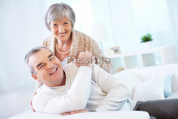 Portrait of a happy senior couple looking at camera with smiles