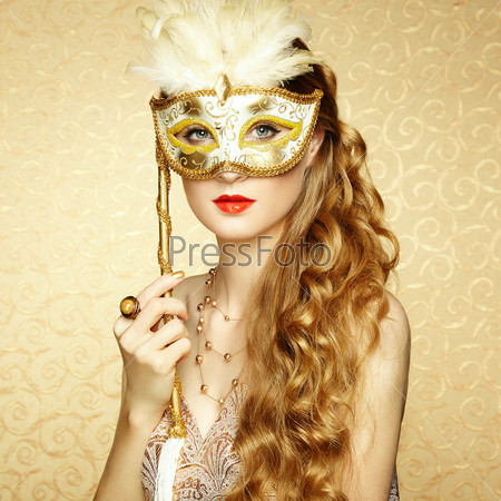 Beautiful Young Woman In Mysterious Golden Venetian Mask. Fashion Photo