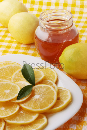 Flavored honey and lemon on a plate