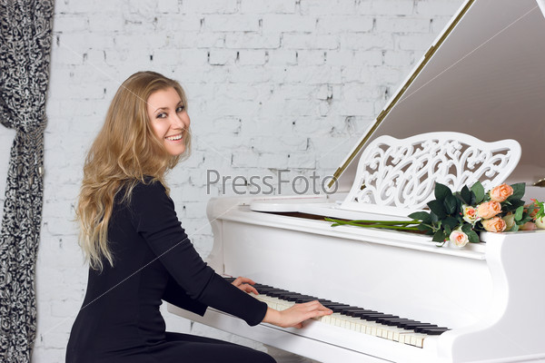 Young woman playing the white piano