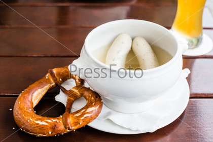 Weisswurst - typical Bavarian white sausages with Pretzel and Hefeweizen (wheat beer)