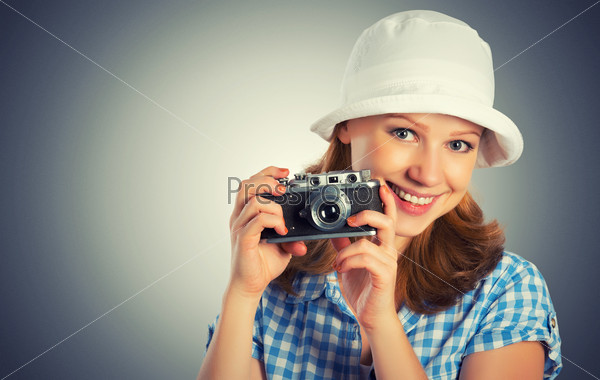 Young female photographer with retro camera