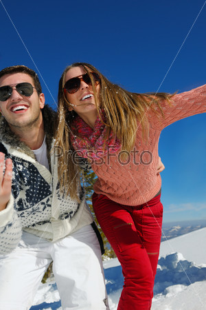 Young Couple In Winter Snow Scene