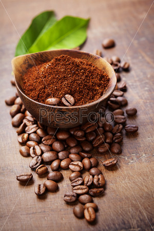 Wooden Bowl With Ground Coffee On Wooden Table
