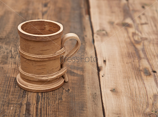 Wooden cup on old wooden table
