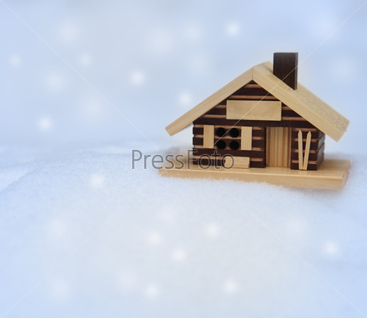 Small wooden house on the white fresh snow
