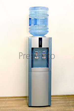 Electric water cooler against the background walls of the office