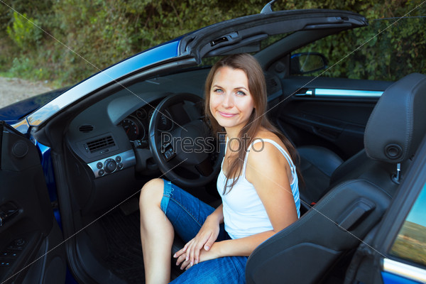 Happy caucasian woman in a cabriolet car