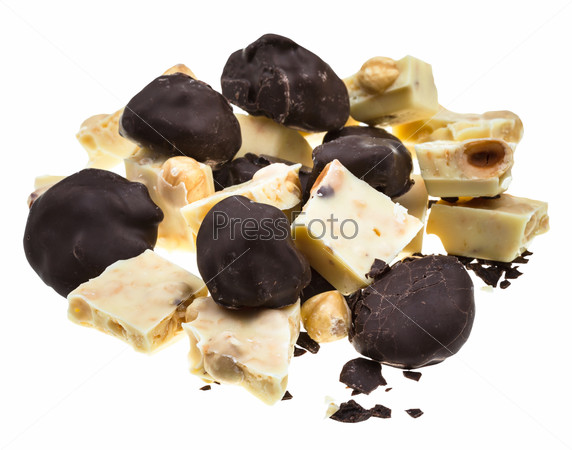 assorted chocolates of plums in dark chocolate and white chocolate with hazelnuts isolated on white background