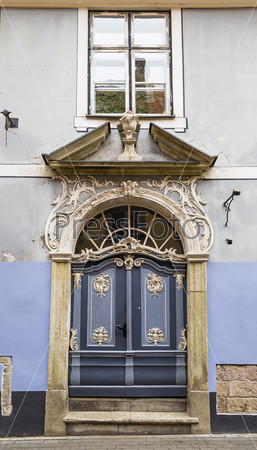 The front door to the old house with stucco decorations
