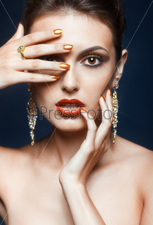 Beautiful young woman with vogue shining face makeup