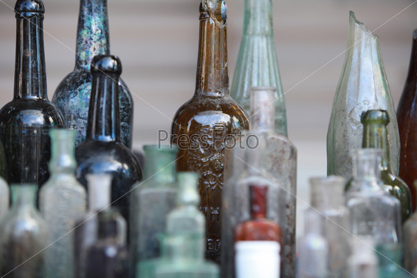several old bottle on the table close to