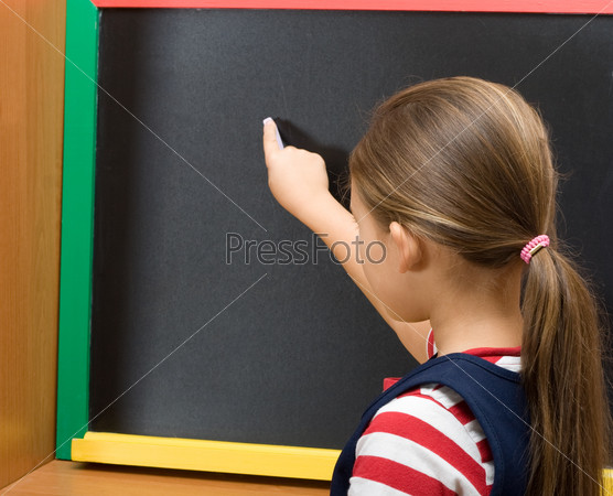 pupil draws on a chalk board