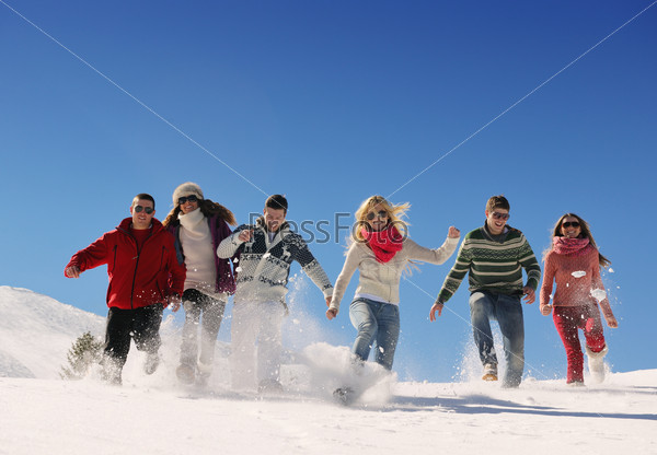 happy friends group  have fun at winter on fresh snow, healthy young people outdoor
