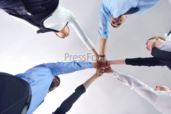 Business People Group Joining Hands And Representing Concept Of Friendship And Teamwork, Low Angle View