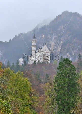 Neuschwanstein castle in Germany. View with mountains. Raining frog mood.
