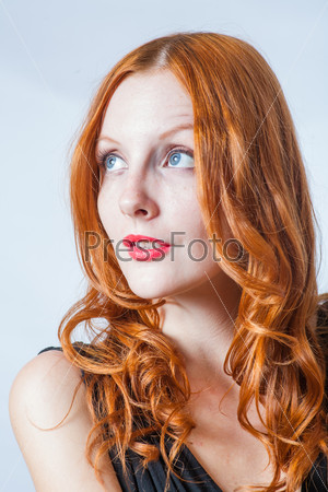 redhead women in studio. Head and shoulders shot. Looking up.