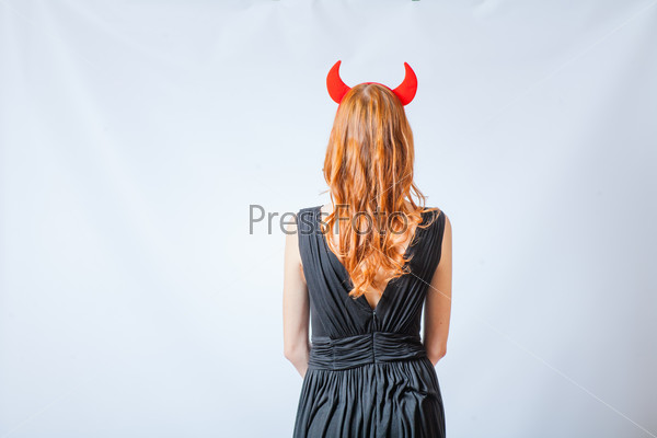 back side of the red haired girl with horns like a devil
