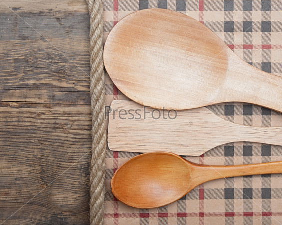 Kitchen tools on vintage wooden background.