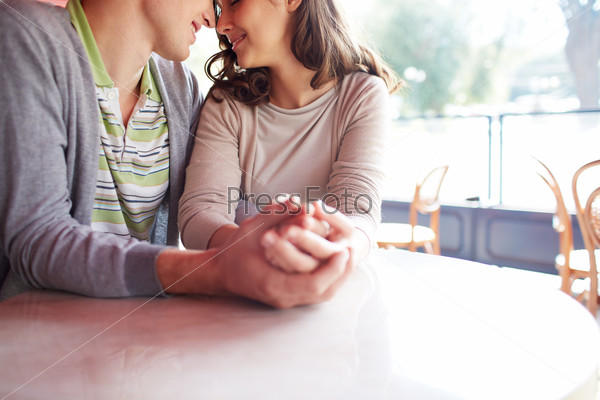 Close-up of romantic couple sitting in cafe on summer day