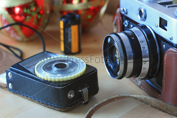 Vintage film camera, light meter and film
