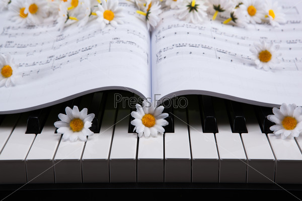 Piano keys and musical book and flower