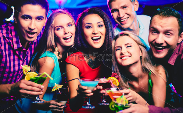 Group of happy friends with cocktails toasting at party