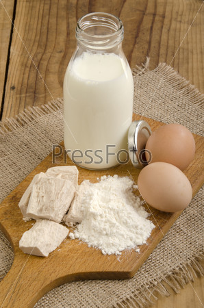baking ingredients, milk, flour, organic eggs and fresh yeast