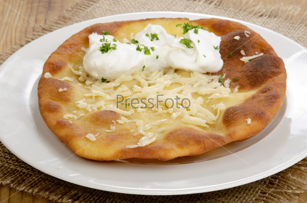 Langos, home made Hungarian pancake with sour cream and cheese