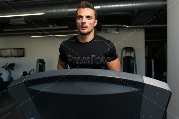 Exercising On A Treadmill. Man Running On Treadmill At A Health Club