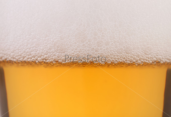 Light beer background. Half background froth and beer.