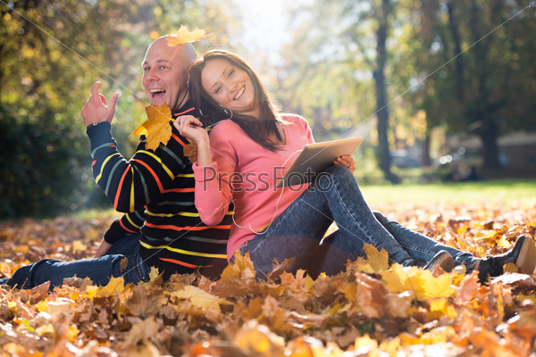 Couple With Headphones Enjoying Music In Autumn