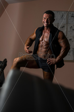 male bodybuilder smiling in black shirt without sleeves