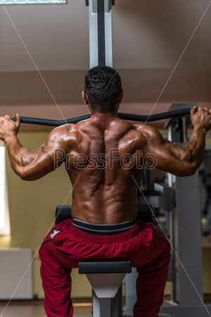 bodybuilder doing heavy weight exercise for back