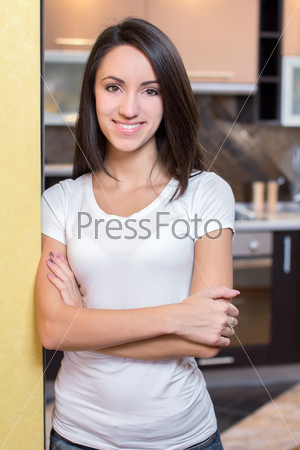 Kitchen Woman. Portrait of young beautiful woman. Kitchen background