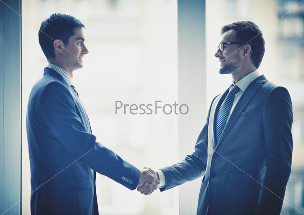 Photo Of Successful Businessmen Handshaking After Striking Deal