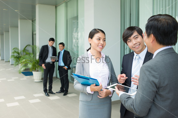 Copy-spaced image of business staff explaining something together on the foreground
