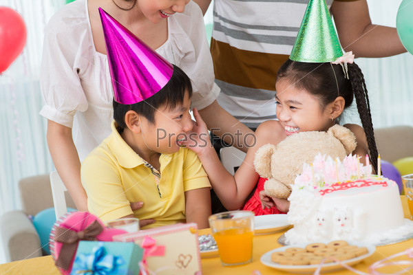 Image of funny children laughing during the family party on the foreground