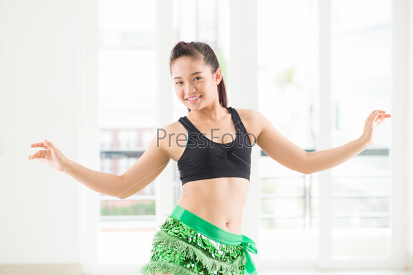 Portrait of a young belly dancer in a fancy eastern costume
