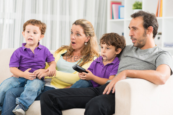 Close up image of a family spending their evening together watching TV at home