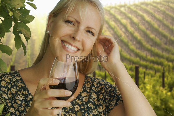 Gorgeous Woman Enjoying a Glass of Wine at the Vineyard
