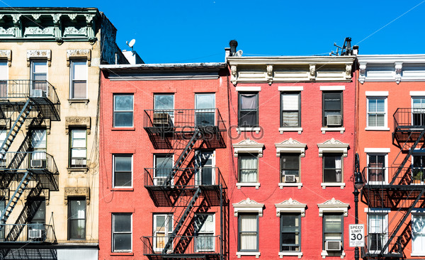 fire laddesrs at beautiful colorful house facades downtown in New York